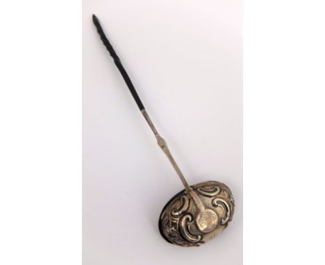 A toddy ladle by John Langlands and John Robertson, London, unmarked, the oval bowl embossed with foliate decoration, set wit