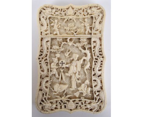 A Chinese ivory export card case finely and deeply carved with figures at play in gardens with dragon and cloud scroll border