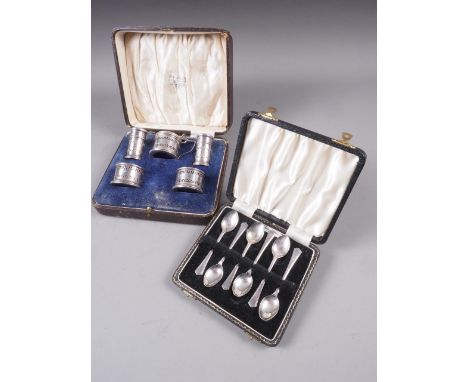 A five-piece silver cruet set with pierced decoration and blue glass liners, a cased set of six coloured enamel on silver cof