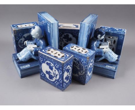 A pair of Chinese blue and white pottery book ends, formed as figures reading, 8 3/4" high, and five other blue and white cer