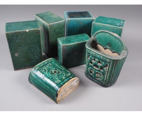 A pair of Chinese green glazed wall pockets with pierced and character decoration, 7 1/2" high, and five similar ceramic pill
