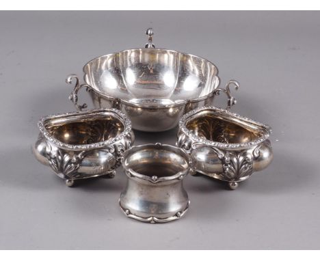 A pair of silver salt cellars with embossed decoration, a silver lobed bonbon dish and a silver napkin ring, 6.3oz troy appro