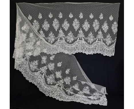 A late 19th century Brussels lace applique skirt overlay flounce, the bobbin lace design edged with needle lace, 180" x 42 1/