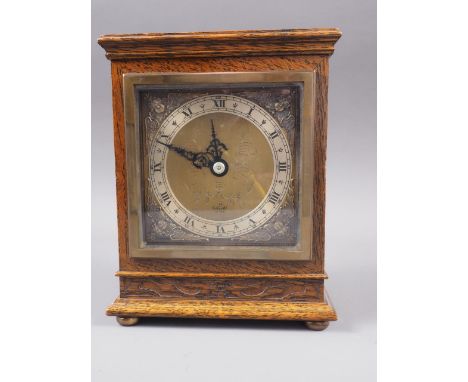 An Elliot oak cased mantel clock with engraved brass dial, 7" high 
