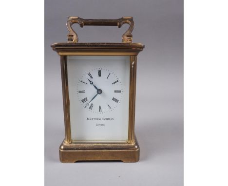 A Matthew Norman brass cased carriage clock with white enamel dial and Roman numerals, 4 3/4" high 