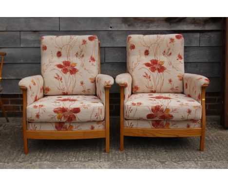 A pair of Ercol showframe armchairs with loose seat and back cushions 