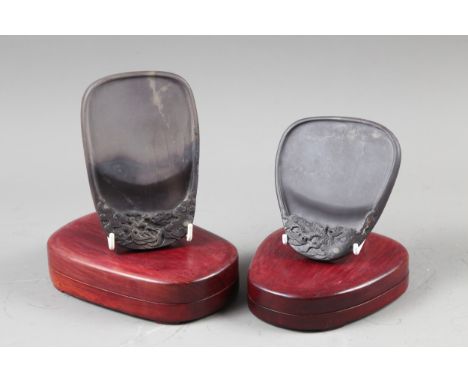 A Japanese teardrop-shaped ink stone decorated dragon and flaming pearl, in hardwood box, and another similar 