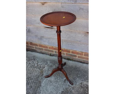 A turned mahogany jardiniere stand, on carved tripod splay supports, 14" dia x 37" high, and two mahogany wine tables, on tur