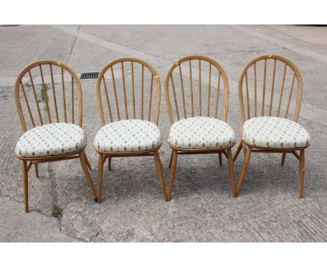 A set of four Ercol elm hoop and spindle back dining chairs, on splay supports&nbsp;with cushions