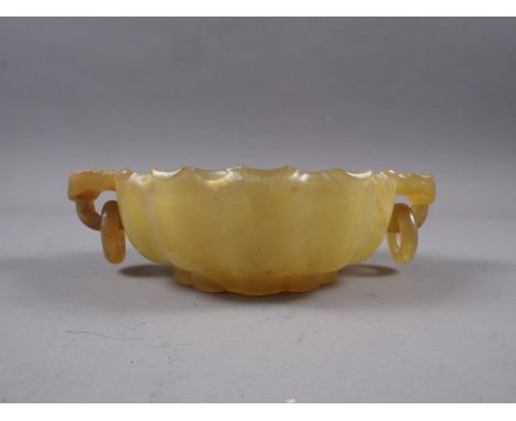 A Chinese jade lotus dish with ring handles, 5 3/4" high 