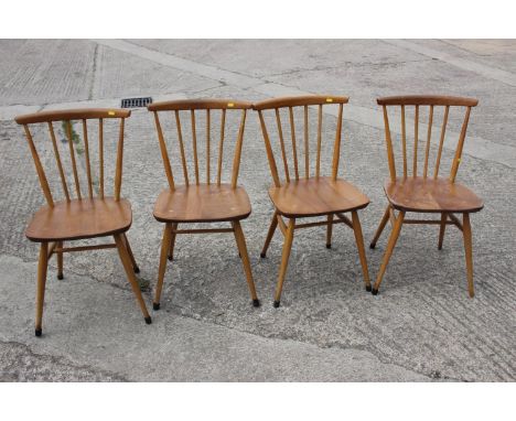 A set of four Ercol 449 ash bow and spindle back dining chairs, on turned and stretchered supports