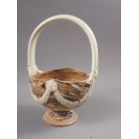An 18th century agate ware basket with swag decoration, on a marbled ground