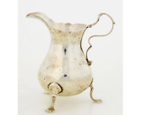 A GEORGE III SILVER CREAM JUG 9cm h, maker's mark rubbed, -K, London 1772, 2ozs ++Minor dents and light wear consistent with 