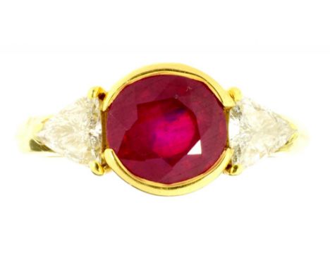 A RUBY AND DIAMOND THREE STONE RING  the larger central ruby between triangular diamond shoulders, indistinctly marked, 4.7g,