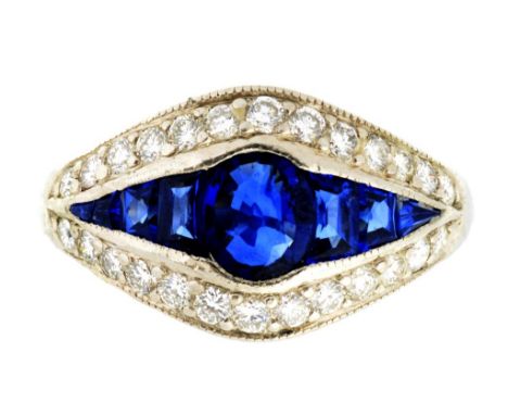 A SAPPHIRE AND DIAMOND RING with larger central cushion shaped sapphire,  in platinum, 2000, 9.3g, size K ++In second hand co