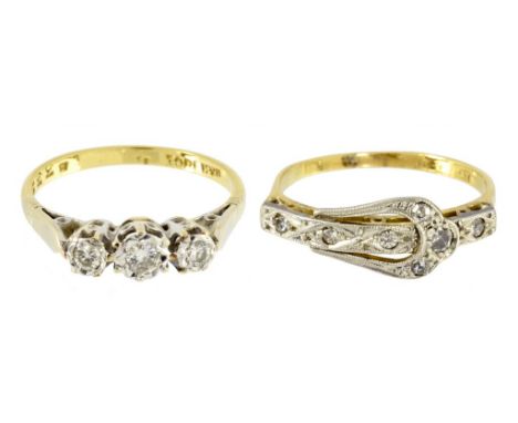 A DIAMOND THREE STONE RING AND A DIAMOND BUCKLE RING  both in gold, marked 18ct PLAT, 4.3g, sizes J and K ++Both with light w