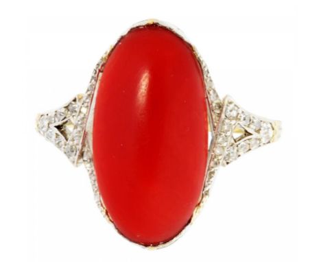 A FRENCH CORAL AND DIAMOND RING  the oval coral cabochon between pierced diamond shoulders, in gold,   control mark, 6.5g, si