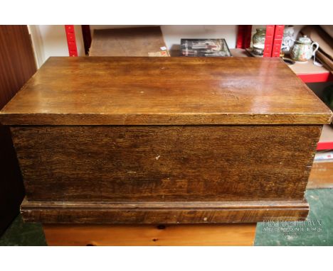 A stained pine trunk painted with faux wood grain effect, metal handles