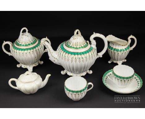 A Staffordshire porcelain part tea service, the body reeded and decorated with a dotted turquoise band with gilt vermiculatio