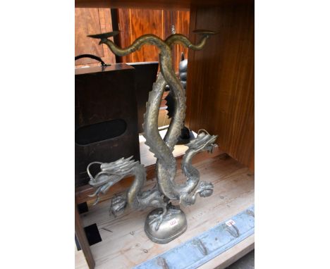 A large Chinese brass dragon form candlestick,&nbsp;65.5cm high.&nbsp; 