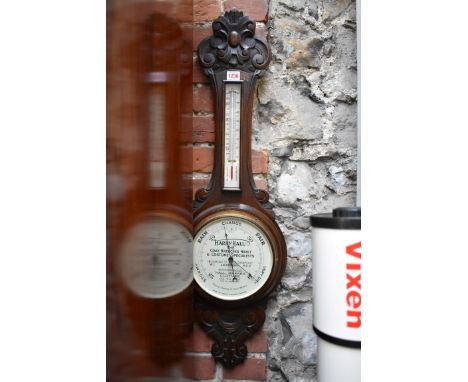 An early 20th century carved oak aneroid banjo barometer, by Short &amp; Mason, with unusual 'Harry Hall Ltd advertising dial
