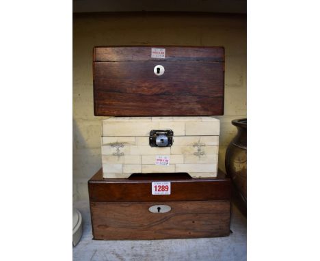 A 19th century rosewood tea caddy, 23cm wide; together with a similar vanity box, 25cm wide; and another bone casket.&nbsp; 