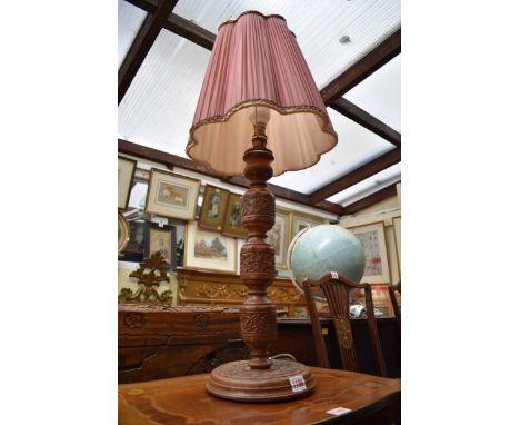 An Indian carved teak table lamp.&nbsp; 