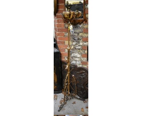 (HP) An antique brass tripod adjustable standard oil lamp. 