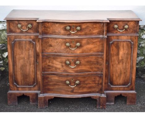 A George III mahogany serpentine fronted commode, possibly attributable to the workshop of Thomas Chippendale, 121cm wide, wi