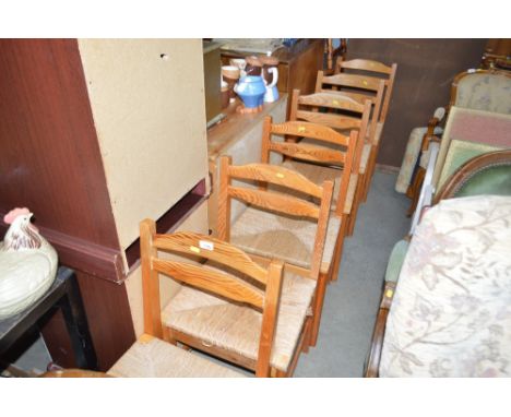 A set of six string seated pine ladder back dining chairs