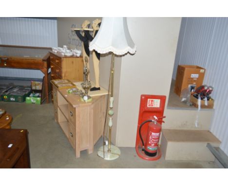 A brass standard lamp and shade