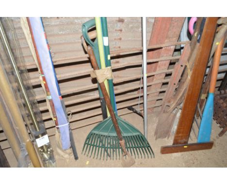 A bundle of long handled gardening tools