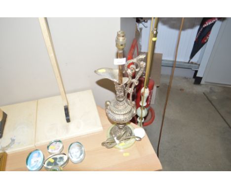 A brass table lamp lacking shade