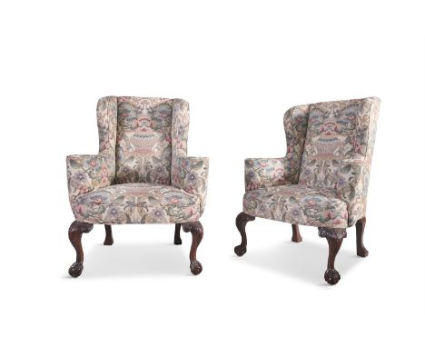 A PAIR OF GEORGE III MAHOGANY FRAMED WINGBACK ARMCHAIRS, with out-scrolled arms, upholstered in fine floral tapestry, raised 