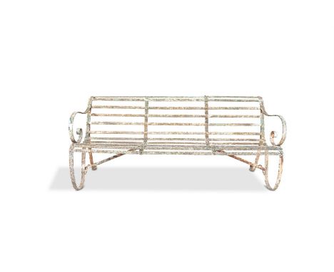 A VICTORIAN WROUGHT IRON GARDEN BENCH,  of scroll form, with slatted seat and back, on scroll supports. 181cm wide