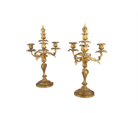 A PAIR OF FRENCH ORMOLU ROCOCO FOUR LIGHT CANDLESTICKS, 19TH CENTURY, naturalistically cast with three leafy scroll arm branc