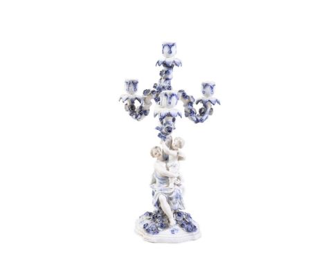 A MEISSEN BLUE AND WHITE PORCELAIN TABLE CANDELABRUM, with detachable four light sconce above a column with mother and child,