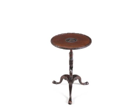 AN IRISH GEORGIAN MAHOGANY CIRCULAR SNAP-TOP WINE TABLE, the top with reserve carved with a sea serpent and with leaf carved 