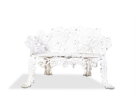 A 19TH CENTURY CAST IRON COMPACT GARDEN BENCH, the open pierced frame formed by trailing vines with hanging fruit, raised on 
