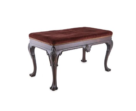 AN IRISH GEORGE III MAHOGANY RECTANGULAR STOOL WITH UPHOLSTERED SEAT, C.1760, covered in claret velour, with shell carved fri