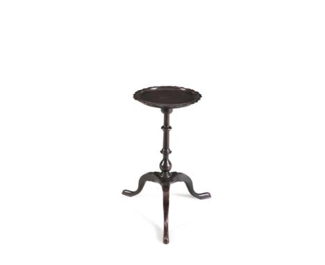 A LATE GEORGE III MAHOGANY WINE TABLE, the circular dished top with wavy rim and raised on turned centre pillar and arched tr