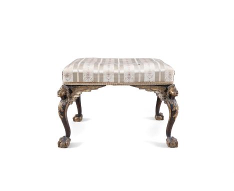 A MAHOGANY AND PARCEL GILT STOOL, of rectangular form, the knees in the form of winged putti on tapering legs and claw and ba
