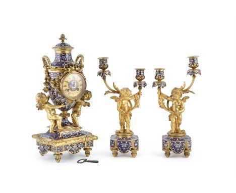 A FINE FRENCH ORMOLU CHAMPLEVE ENAMEL THREE PIECE CLOCK SET, comprising of an urn-shaped mantle clock and a pair of figural c