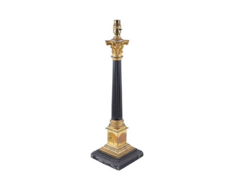 A GILT AND BRONZED METAL CORINTHIAN COLUMN TABLE LAMP, with shade