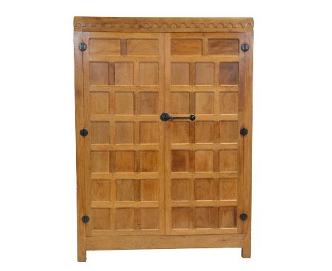 Robert 'Mouseman' Thompson of Kilburn, an oak panelled double wardrobe, 1970s, halfpenny moulded top, the interior fitted wit