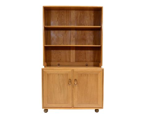 Ercol, Windsor bookcase cabinet, the upper open section fitted with two adjustable shelves, above pair of cupboards, rollerba