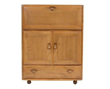 Ercol, a Windsor serving cabinet/ bureau, with fall front enclosing part fitted interior, above pair of cupboards with single