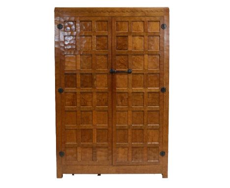 Robert 'Mouseman' Thompson of Kilburn, an oak double wardrobe, 1941, all over adzed panelling, halfpenny moulded top, the int