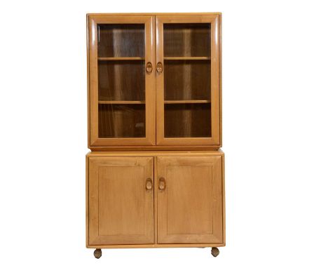 Ercol, glazed bookcase cabinet, the shallow upper section with glazed doors enclosing two adjustable shelves, above a deep cu