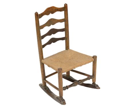 Arts and Crafts child's rocking chair, in the manner of Ernest Gimson, elm and ash, ladder back with rush seat, turned legs a